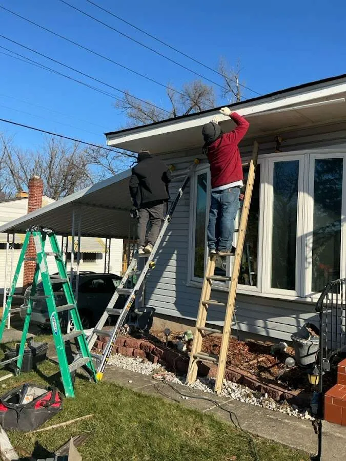 Restoration crew performing exterior repair in Harvest